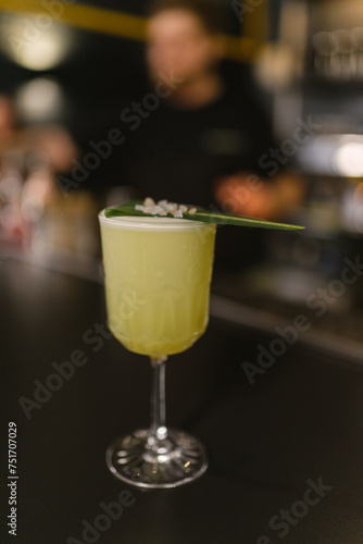 Fruit alcoholic cocktail served in glass with fresh leaf and coarse salt. Alcohol beverage with professional serving concept