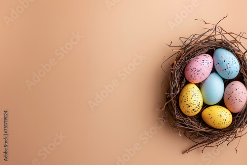 Easter eggs on a colored background, nest with Easter eggs of different colors on a beige paper background, bright Easter background with place for text