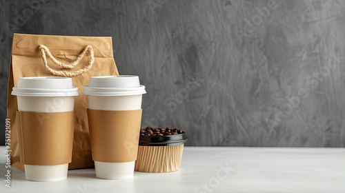 Two coffees in plastic glasses, a cupcake and an eco-bag on a gray dark background