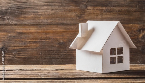 paper house on wooden background