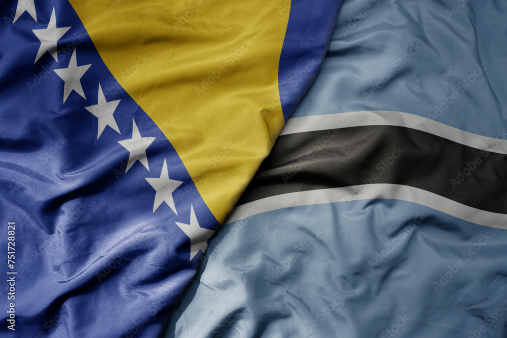 Fototapeta premium big waving national colorful flag of botswana and national flag of bosnia and herzegovina.