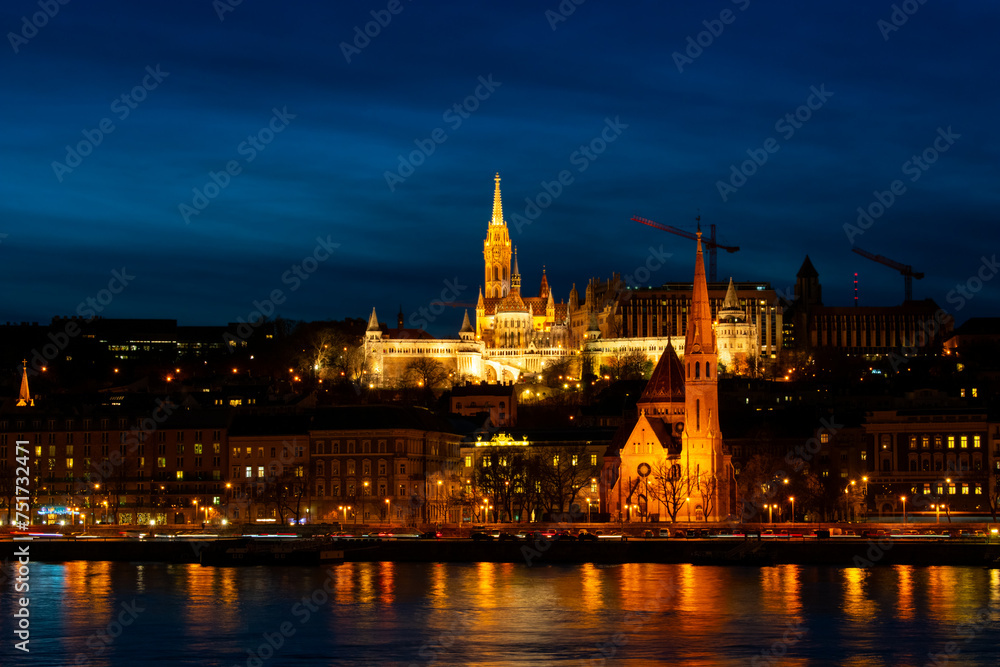 Naklejka premium Matthias Church illuminated at night in Budapest, Hungary