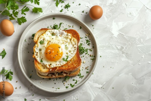 Croque madame sandwich displayed on a lit plate