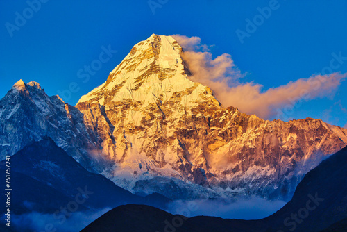 Resplendent Ama Dablam is bathed in the golden light of a scenic Himalayan sunset as seen from the scenic village of Pangboche in the upper Khumbu, Nepal photo