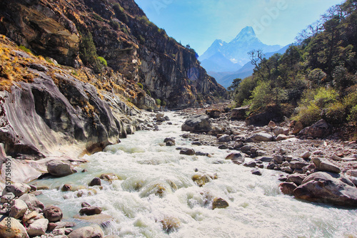 Scenic view of Ama Dablam rising from the mists in the deep valleys of the Dudh kosi river in Nepal photo