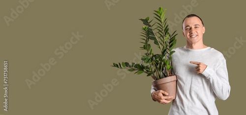 Young man holding houseplan...