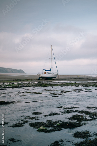 Sailboat on the beach at Abersoch photo