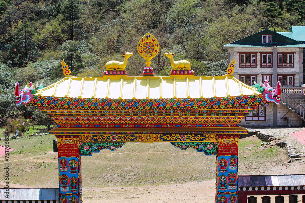 Entrance gate to the Dawa Choling Tibetan Buddhist Monastery situated at 3867 meters in Tengboche village, Nepal - obrazy, fototapety, plakaty 
