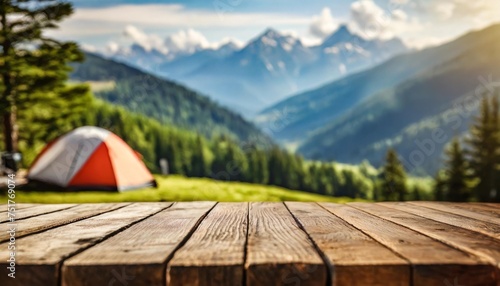 wooden table background of free space for your decoration and blurred background of camping in mountains