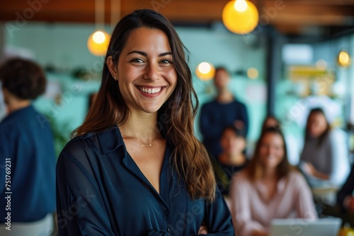 smiling curly hair woman standing in front of the team is dressed in modern blue clothes on meeting with team working some project and she lead the team to create a plan