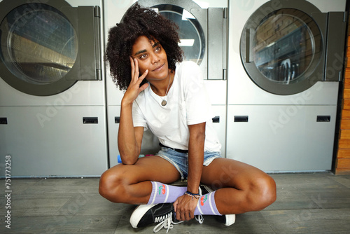 Photo of  fashionable young woman waiting for laundry.