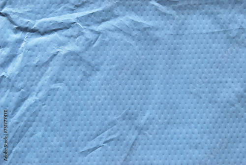 A sheet of gray wrinkled perforated parcel surface texture as background