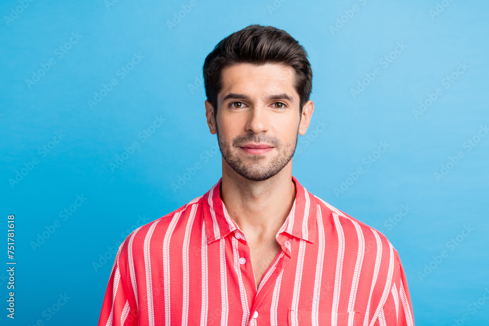 Photo of positive good mood young man dressed striped shirt smiling isolated blue color background Photo of positive good mood young man dressed striped shirt smiling isolated blue color background