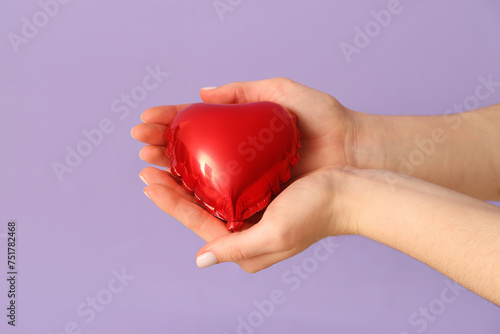 Red heart shaped balloon in...