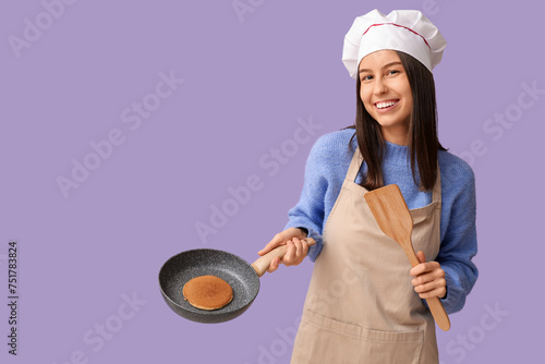 Young female chef holding f...