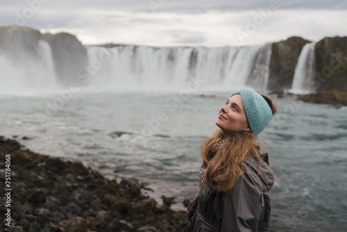 Fototapeta Naklejka Na Ścianę i Meble -  Traveling and exploring Iceland landscapes and travel destinations. Young female tourist enjoying the view and outdoor spectacular scenery. Summer tourism by Atlantic ocean and mountains.