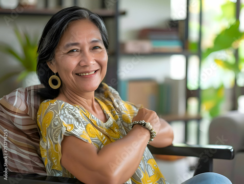 Portrait of a beautiful mature experienced senior filipino business woman taking a break in her chair in her living room