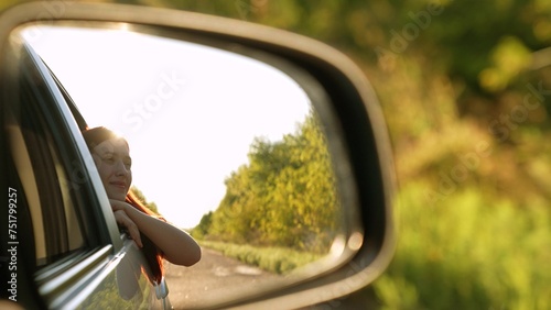 Smiling travel woman looking at window car road trip enjoy summer trees sun light back mirror reflection view. Happy female tourist admiring scenery freedom explore lifestyle adventure auto driving