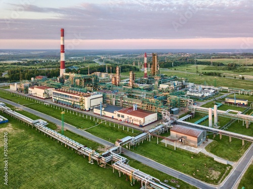 Panoramic view of a large modern oil refinery at sunset.