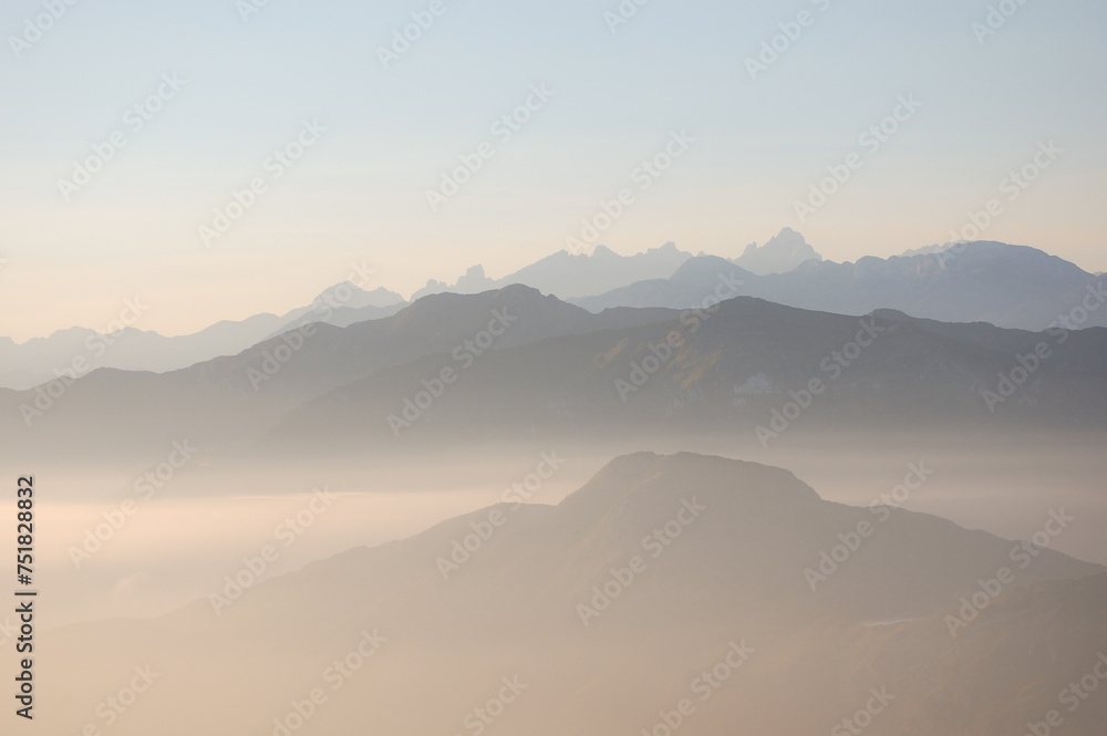 infinite sunrise over mountains in a misty day