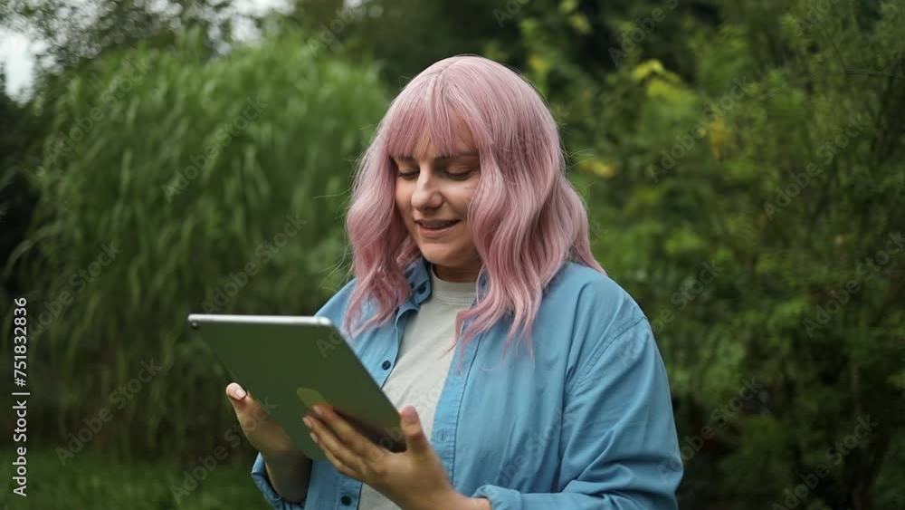 A beautiful and happy Caucasian woman used her digital tablet outdoors. Urban city lifestyle concept A beautiful and happy Caucasian woman used her digital tablet outdoors. Urban city lifestyle concept