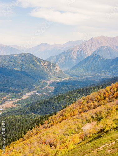 mountains, sky and green and yellow forest in valley. Place for trekking tourism
