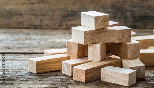 heap of wooden blocks tower game on wood background