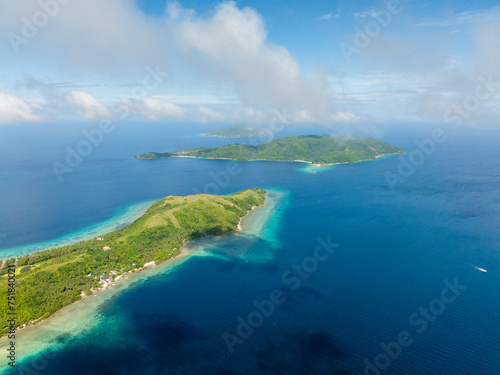 Tropical scenery of Islands with beach and blue sea. Blue sky and clouds. Romblon, Philippines.
