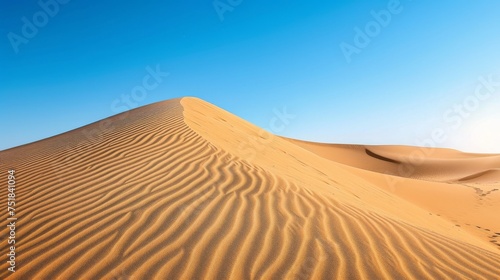 Shimmering sand dunes under a clear blue sky
