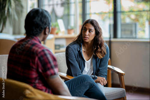 A woman engages in a serious discussion with her therapist, embodying vulnerability and concern, highlighting the importance of mental health support.