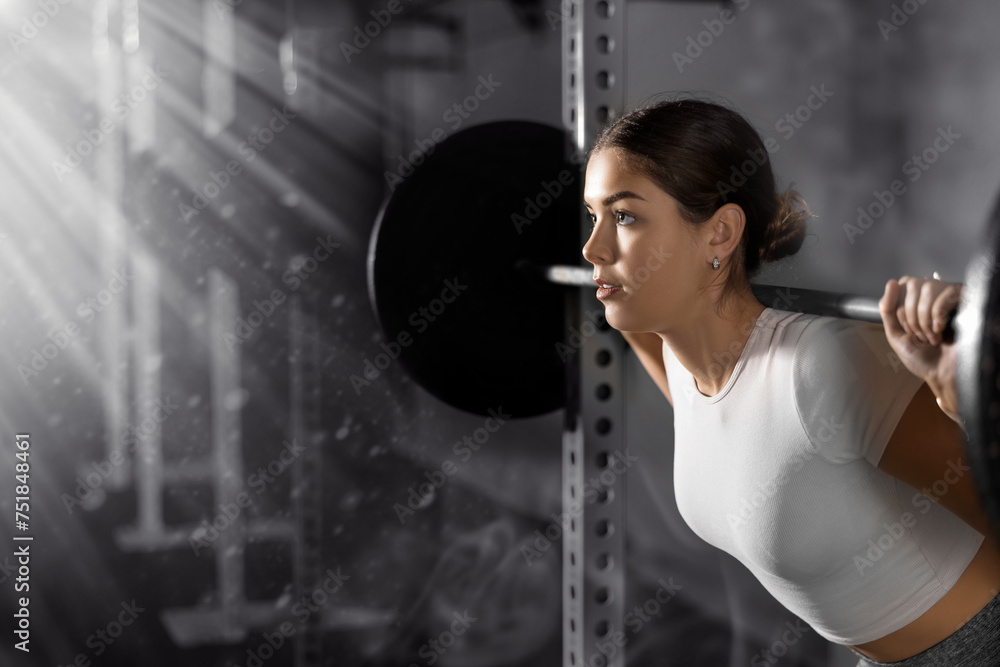 Caucasian young woman training with barbell using squat rack in crossfit gym - obrazy, fototapety, plakaty 