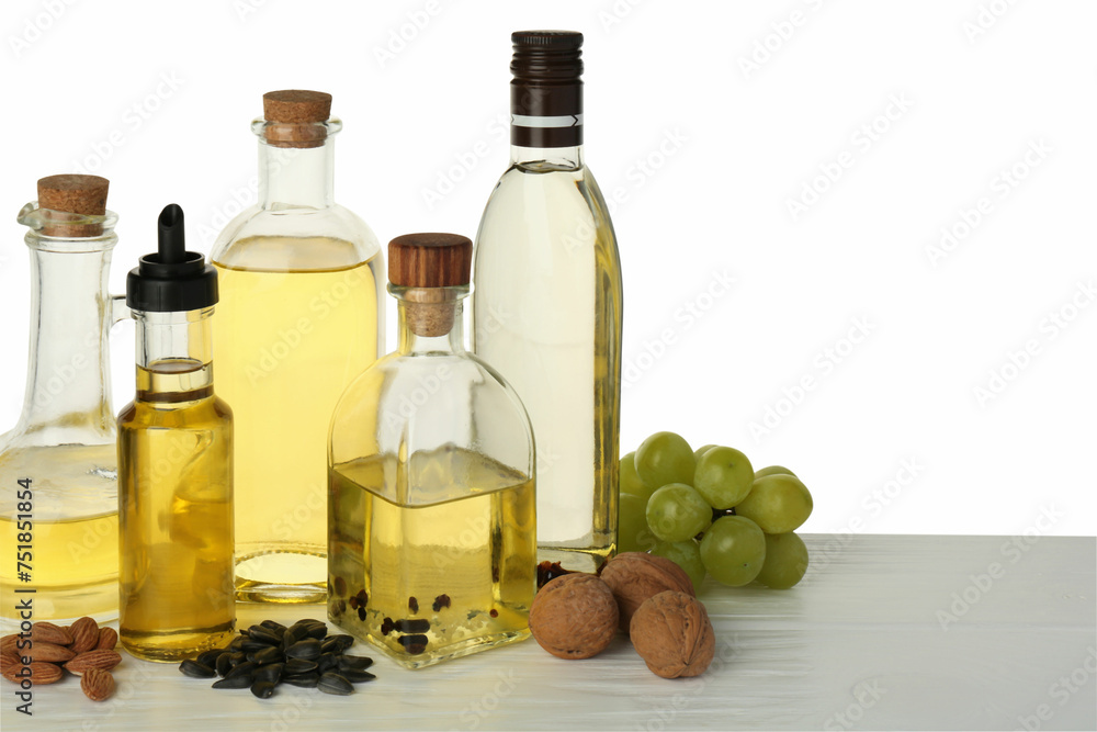 Vegetable fats. Different cooking oils and ingredients on wooden table against white background Vegetable fats. Different cooking oils and ingredients on wooden table against white background