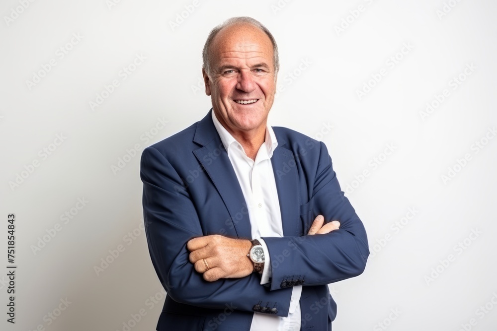 Portrait of a happy senior businessman smiling at the camera with his arms crossed Portrait of a happy senior businessman smiling at the camera with his arms crossed