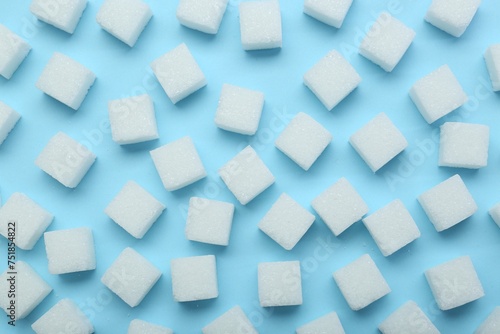 White sugar cubes on light blue background  top view