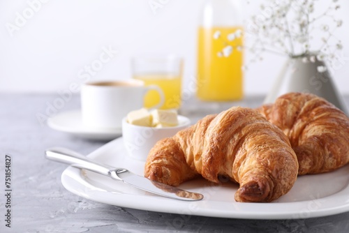Tasty breakfast. Fresh croissants and butter on grey table  closeup