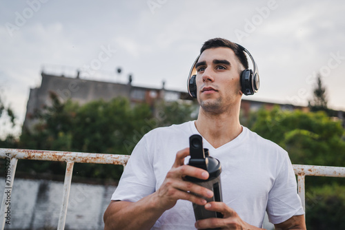 Photos athlete man caucasian male hold supplement shaker outdoor