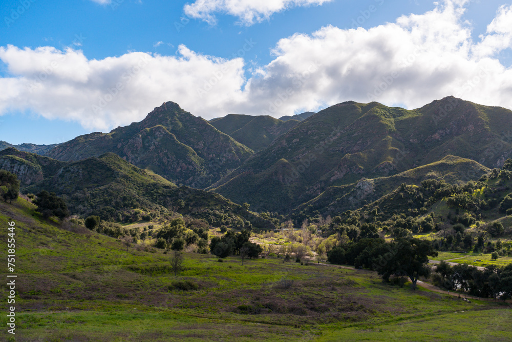 Views mountains, hills, rivers, lush grass and foliage, while hiking during the spring in Malibu Creek State Park.