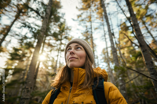 Young woman with backpack hiking in the forest. Hiking concept. 
