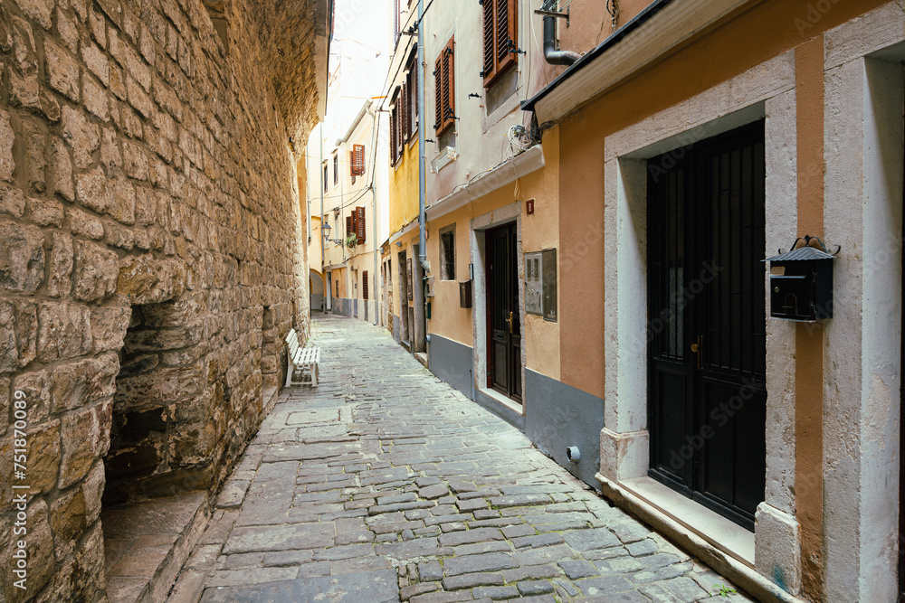Fototapeta premium Narrow Street with Old Buildings in Town Piran, Slovenia