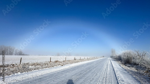 Ice rainbow in the winter along a country road with snow © Lori