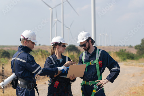 engineers working in fieldwork outdoor. Workers walking and inspect construction and machine around project site. Wind turbine electrical of clean resource enerdy and environment sustainable. photo