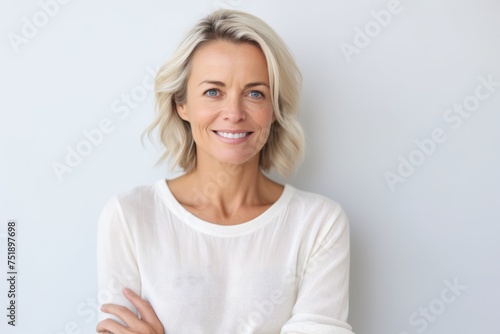 Portrait of a beautiful middle-aged woman smiling at the camera © Iigo