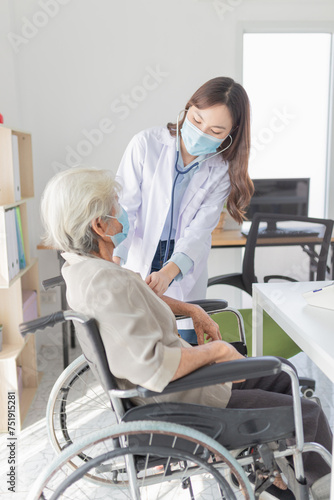 Asian doctor talk with old female patient about disease symptom, doctor use stethoscope listening lung of patient, elderly health check up , they wear surgical mask in hospital, corona virus 