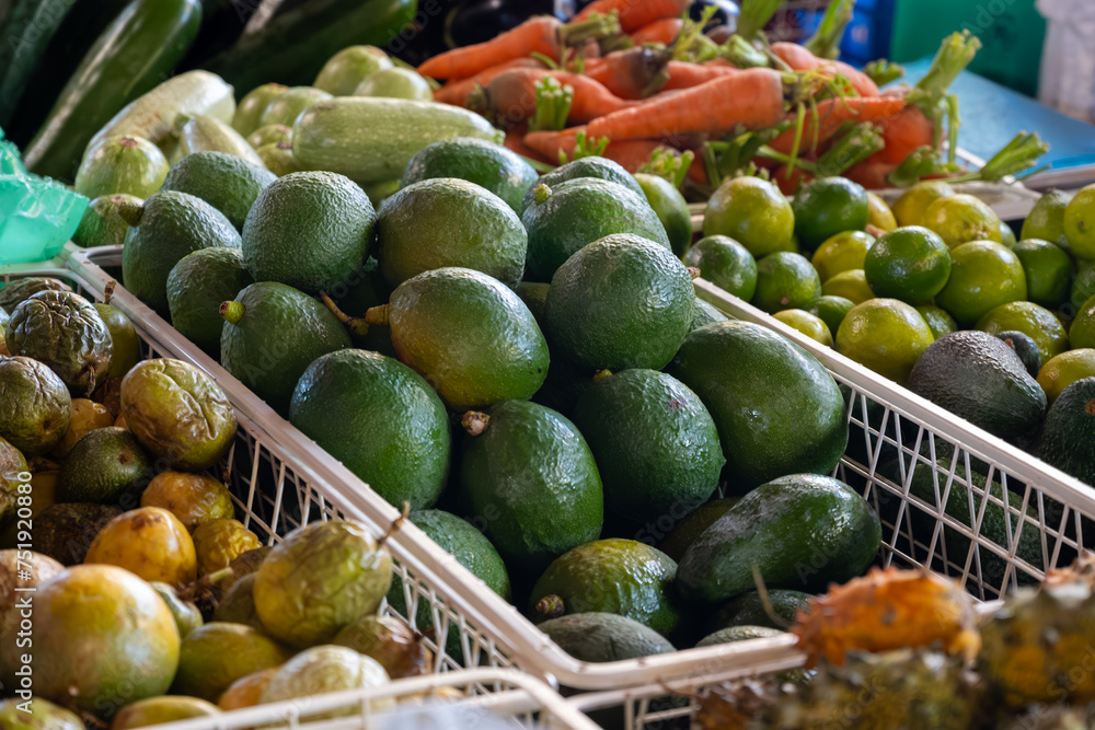 Fresh ripe green avocados, tropical fruits and vegetables on farmers market on Fuerteventura, Canary islands, Spain Fresh ripe green avocados, tropical fruits and vegetables on farmers market on Fuerteventura, Canary islands, Spain