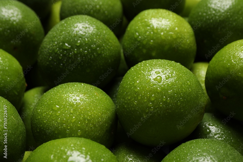 Fresh ripe limes with water drops as background, closeup Fresh ripe limes with water drops as background, closeup