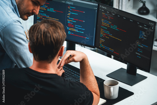 IT developers discussing online software development information on pc screen, creating program coding for latest version application on website. Concept of brainstorming firmware updated. Sellable.