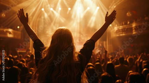 woman at a concert, viewed from behind, hands raised, fully immersed in the musical experience generative ai