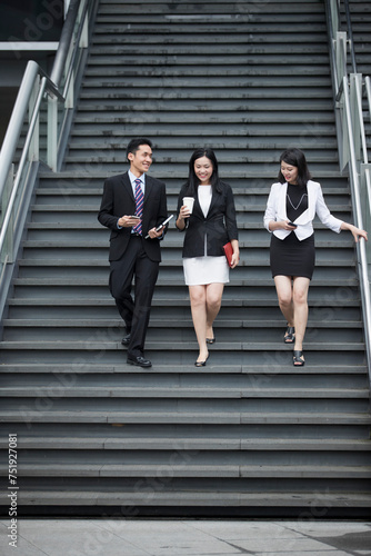 Three Asian Business people talking.