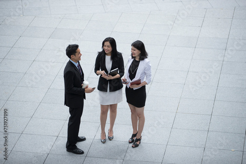 Elevated view of 3 Asian Business people.