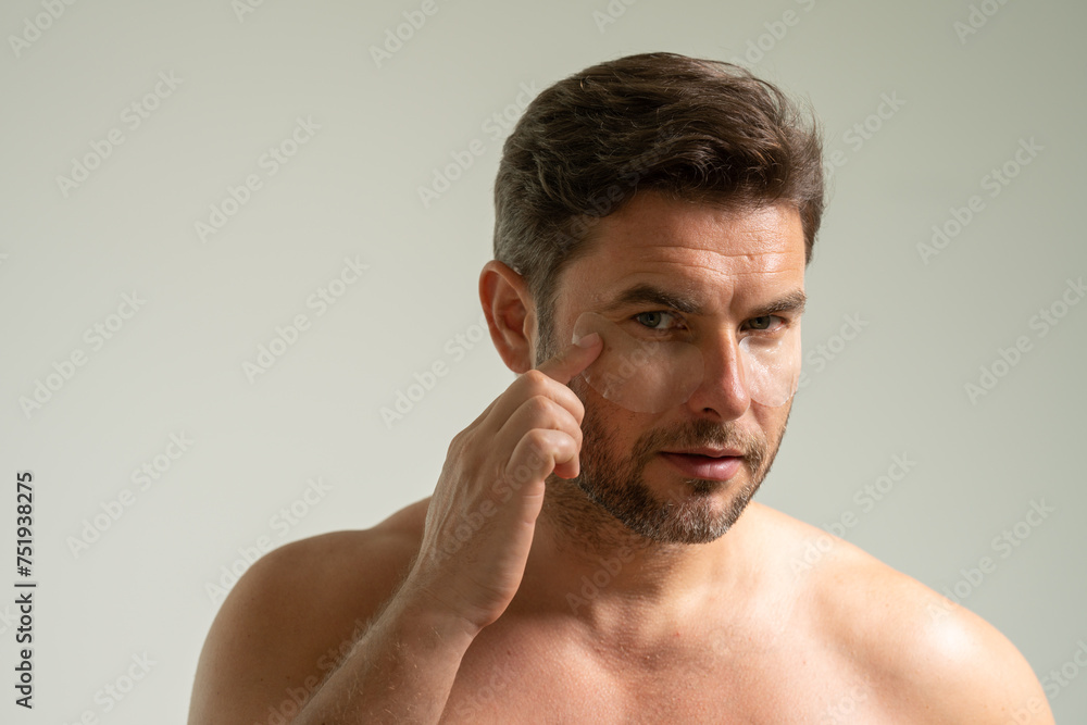 man with healthy skin. Head shot portrait smiling American young man with naked shoulders checking wrinkles or acne on forehead, looking at camera, facial cosmetology, treatment, skincare concept man with healthy skin. Head shot portrait smiling American young man with naked shoulders checking wrinkles or acne on forehead, looking at camera, facial cosmetology, treatment, skincare concept
